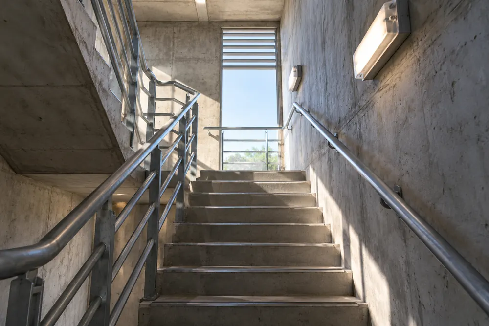 Illuminated escape stairwell illustrating emergency lighting checks for Nottingham businesses